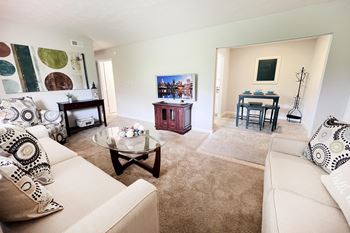 A living room with a white couch and a coffee table.